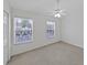 Bright bedroom featuring a ceiling fan, carpet and two windows at 1256 Redondo Way, Wesley Chapel, FL 33543