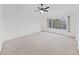 Large carpeted bedroom with a ceiling fan and a large window at 1256 Redondo Way, Wesley Chapel, FL 33543