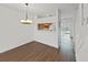 Dining area showing hardwood floors and view to the kitchen with matching cabinets at 1256 Redondo Way, Wesley Chapel, FL 33543