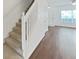 Home entryway with hardwood flooring and natural light, leading to carpeted stairs at 1256 Redondo Way, Wesley Chapel, FL 33543