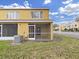 Back of the home, featuring a screened-in patio and outdoor space at 1256 Redondo Way, Wesley Chapel, FL 33543