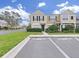 Inviting two-story townhome featuring a manicured lawn and assigned parking spaces at 1256 Redondo Way, Wesley Chapel, FL 33543