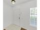 Entryway showcasing tile flooring transitioning to wood-look floors, leading to a bright and inviting living space at 1256 Redondo Way, Wesley Chapel, FL 33543