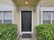 Close-up of the front door, showcasing the house number, decorative trim, and well-maintained landscaping at 1256 Redondo Way, Wesley Chapel, FL 33543