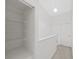 Bright upstairs hallway featuring linen closet and white doors at 1256 Redondo Way, Wesley Chapel, FL 33543