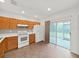 Cozy kitchen with stainless steel appliances, wooden cabinets, and sliding glass door to the yard at 1256 Redondo Way, Wesley Chapel, FL 33543