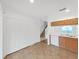 Spacious kitchen featuring ample storage with pantry closets and great sight lines to stairway at 1256 Redondo Way, Wesley Chapel, FL 33543