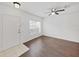 Bright living room featuring wood-look floors, a ceiling fan, and natural light streaming through the window at 1256 Redondo Way, Wesley Chapel, FL 33543