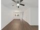Bright living room features hardwood floors, ceiling fan and access to the kitchen area at 1256 Redondo Way, Wesley Chapel, FL 33543