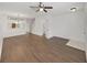 Open-concept living space with wood-look flooring and a view into the kitchen area with a breakfast bar at 1256 Redondo Way, Wesley Chapel, FL 33543