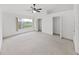 Spacious primary bedroom featuring two walk-in closets, carpet and a ceiling fan at 1256 Redondo Way, Wesley Chapel, FL 33543