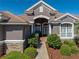 Close-up of the charming front entrance and lush landscape at 12733 Grand Traverse Dr, Dade City, FL 33525