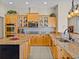 Spacious kitchen featuring stainless steel appliances, granite countertops, large center island and lots of cabinet space at 12733 Grand Traverse Dr, Dade City, FL 33525