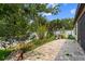 Paver patio in a private backyard with mature trees and a white vinyl fence at 1426 Main St, Valrico, FL 33594