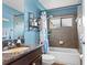 Updated bathroom with granite countertops, shower-tub, and tiled walls at 1426 Main St, Valrico, FL 33594