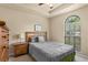 Relaxing bedroom with a large window, neutral walls, and a tray ceiling feature at 1426 Main St, Valrico, FL 33594