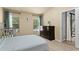 Bedroom with laminate floors, crib, windows with blinds, and a dark wood dresser on display at 1426 Main St, Valrico, FL 33594