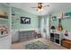 Inviting bedroom featuring carpet floors, large dresser, a ceiling fan, and whimsical decor at 1426 Main St, Valrico, FL 33594