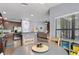 Eat-in kitchen features a round table adjacent to kitchen island and an open floor plan to living area at 1426 Main St, Valrico, FL 33594