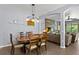 Relaxing dining area with views to the living room and featuring a modern light fixture at 1426 Main St, Valrico, FL 33594