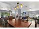 Open concept dining area featuring modern lighting and seamlessly connecting to living spaces at 1426 Main St, Valrico, FL 33594