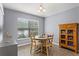 Bright dining room features a round table, tile floors, a large window, and an antique wooden cabinet at 1426 Main St, Valrico, FL 33594
