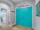 Inviting entryway with colorful double doors, tile flooring, and neutral paint at 1426 Main St, Valrico, FL 33594