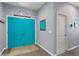 Bright entryway featuring tile floors, gray walls and a teal double entry door at 1426 Main St, Valrico, FL 33594