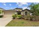 Charming single Gathering home featuring a stone facade, mature landscaping and a two car garage at 1426 Main St, Valrico, FL 33594