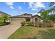 Charming single Gathering home featuring a stone facade, mature landscaping and a two car garage at 1426 Main St, Valrico, FL 33594