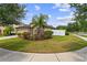 Well-kept home featuring beautiful landscaping, large lawn, and a welcoming front entrance at 1426 Main St, Valrico, FL 33594