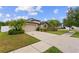 Well maintained home with a spacious front yard, lush landscaping and a two car garage at 1426 Main St, Valrico, FL 33594
