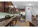 Modern kitchen featuring granite countertops, stainless steel appliances, and ample cabinet space at 1426 Main St, Valrico, FL 33594