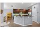 Spacious kitchen with dark cabinets, stainless steel appliances, granite countertops and tile backsplash at 1426 Main St, Valrico, FL 33594