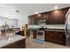 Well-appointed kitchen featuring stainless steel appliances, dark wood cabinetry and a breakfast bar at 1426 Main St, Valrico, FL 33594