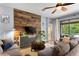 Inviting living room with a stylish wood accent wall, plush seating, and lots of natural light at 1426 Main St, Valrico, FL 33594