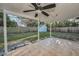 Covered patio with tile flooring overlooking a spacious backyard with a storage shed at 1535 Satsuma St, Clearwater, FL 33756