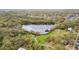 Community aerial view of a lake with lush landscaping, walking paths, and convenient parking at 1621 S Keene Rd, Clearwater, FL 33756