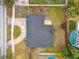 Aerial view of property with a dark roof, light driveway, and private pool at 1621 S Keene Rd, Clearwater, FL 33756