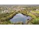 Aerial image of the lake within the community, featuring the surrounding mature trees and landscaping at 1621 S Keene Rd, Clearwater, FL 33756
