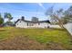 Expansive backyard with a wooden deck and mature trees surrounding the property at 1621 S Keene Rd, Clearwater, FL 33756