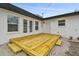 Backyard wooden deck features French doors and a small set of steps at 1621 S Keene Rd, Clearwater, FL 33756
