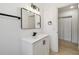 Bathroom featuring a modern vanity with black hardware and framed mirror next to closet at 1621 S Keene Rd, Clearwater, FL 33756