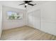Bedroom with closet, fan and windows, light floors and neutral paint at 1621 S Keene Rd, Clearwater, FL 33756