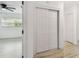 View into bedroom with windows, ceiling fan and access to closet space at 1621 S Keene Rd, Clearwater, FL 33756