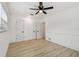 Spacious bedroom with a ceiling fan, wood-look floors, and ample closet space at 1621 S Keene Rd, Clearwater, FL 33756