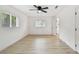 Bright, airy bedroom featuring modern ceiling fan, and light wood-look floors at 1621 S Keene Rd, Clearwater, FL 33756