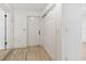 Bright entryway featuring light wood floors, a white closet, and a six-panel white entry door at 1621 S Keene Rd, Clearwater, FL 33756