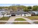 Aerial view of a lovely home with a dark roof, two-car garage, fenced yard, and inviting pool at 1621 S Keene Rd, Clearwater, FL 33756