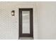 Charming front door framed by painted brick and a stylish outdoor light fixture at 1621 S Keene Rd, Clearwater, FL 33756